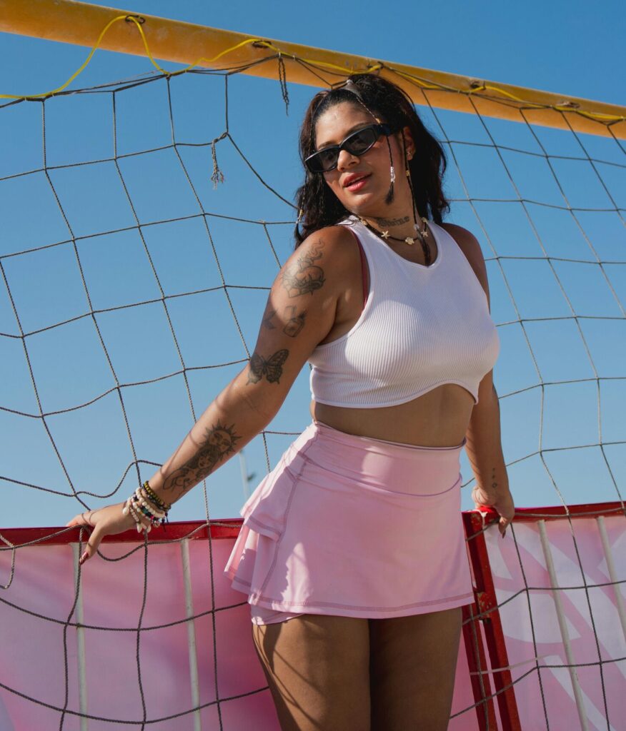 A young woman in athletic wear enjoying a sunny day on the beach at Progreso, Mexico. Vibrant and lively scene.